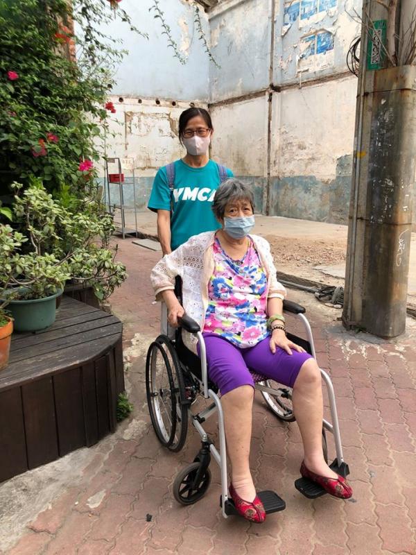 居家服務員帶奶奶出門散步，因肺炎疫情蔓延，服務員也不忘為奶奶戴上口罩防止被感染的風險。